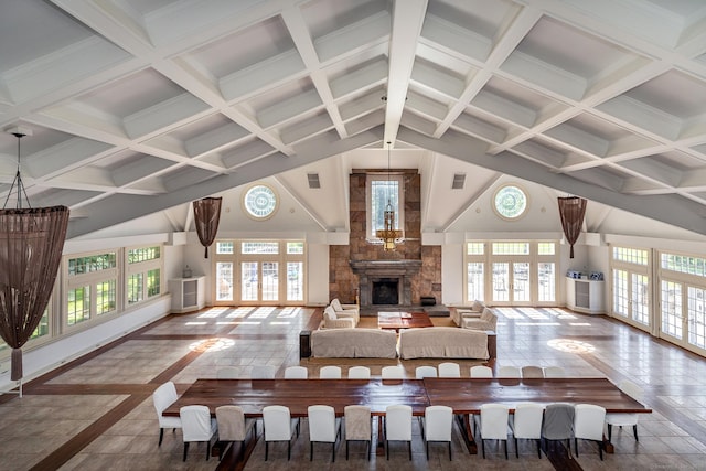 10 Sunny Ridge Rd, Washington, CT 06793 - living area featuring high vaulted ceiling, plenty of natural light, a fireplace with raised hearth, beam ceiling, and french doors