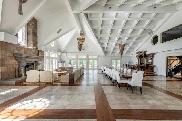 10 Sunny Ridge Rd, Washington, CT 06793 - tiled living area featuring beamed ceiling, a stone fireplace, high vaulted ceiling, and stairway