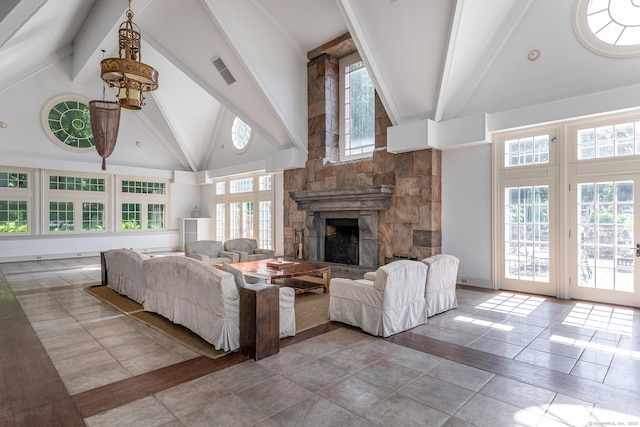 10 Sunny Ridge Rd, Washington, CT 06793 - living area with high vaulted ceiling, beamed ceiling, a stone fireplace, and tile patterned flooring