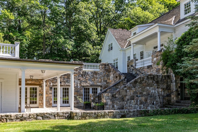 10 Sunny Ridge Rd, Washington, CT 06793 - view of property exterior with stone siding, stairs, a lawn, and a patio area
