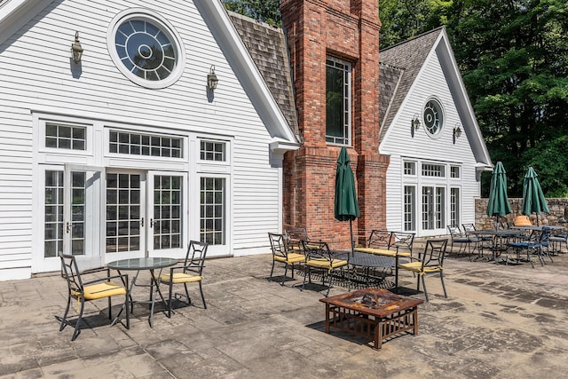 10 Sunny Ridge Rd, Washington, CT 06793 - rear view of property with french doors, outdoor dining area, and a shingled roof