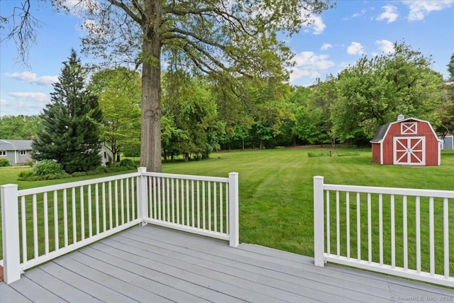 129 Mohawk Dr, Wallingford, CT 06492 - deck featuring a lawn, an outbuilding, view of wooded area, and a barn