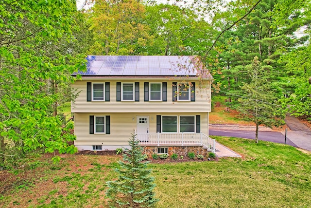 76 Three Mile Hill Rd, Middlebury, CT 06762 - colonial inspired home featuring a front lawn, roof mounted solar panels, and a porch