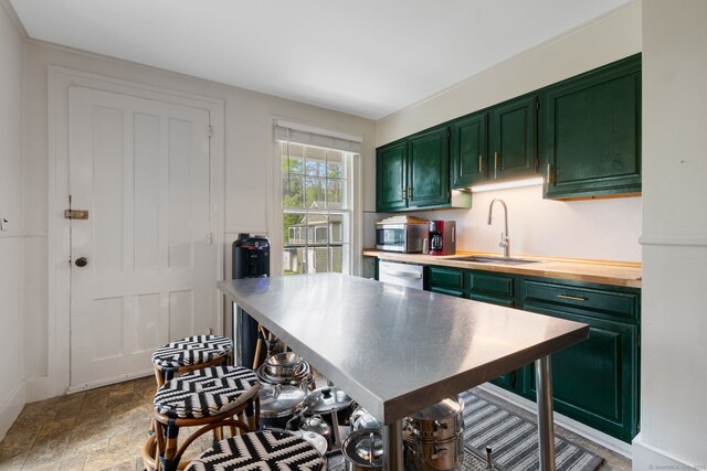 4 Lime Rock Holw, Salisbury, CT 06039 - kitchen featuring green cabinetry, a sink, dishwashing machine, and stainless steel microwave