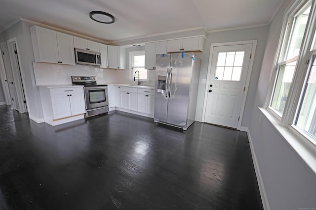 136 Cooper Dr, Waterbury, CT 06704 - kitchen featuring light countertops, crown molding, baseboards, stainless steel appliances, and a sink