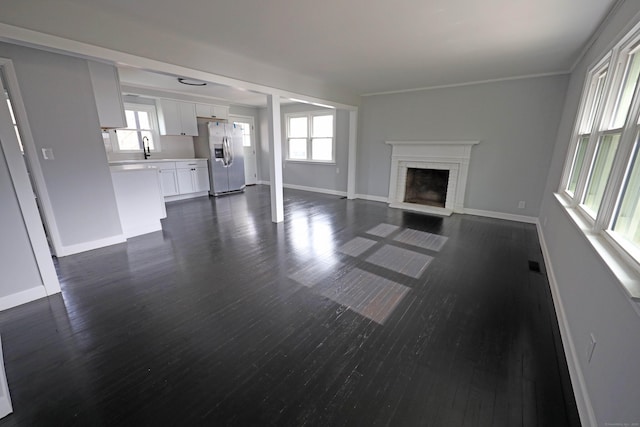 136 Cooper Dr, Waterbury, CT 06704 - unfurnished living room with baseboards, visible vents, a brick fireplace, and dark wood finished floors