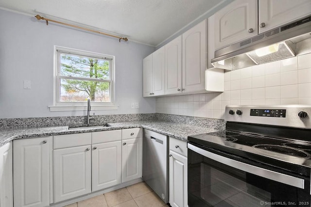 kitchen featuring a sink, appliances with stainless steel finishes, white cabinetry, and under cabinet range hood