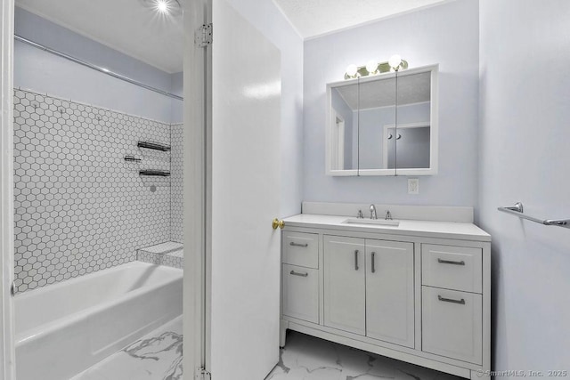 full bath with tub / shower combination, marble finish floor, and vanity