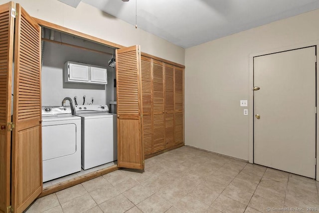 washroom with washer and dryer, light tile patterned floors, and cabinet space