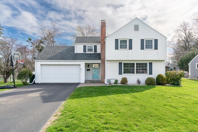 46 Grandview Ter, Wethersfield, CT 06109 - view of front of house featuring roof with shingles, a chimney, an attached garage, aphalt driveway, and a front yard