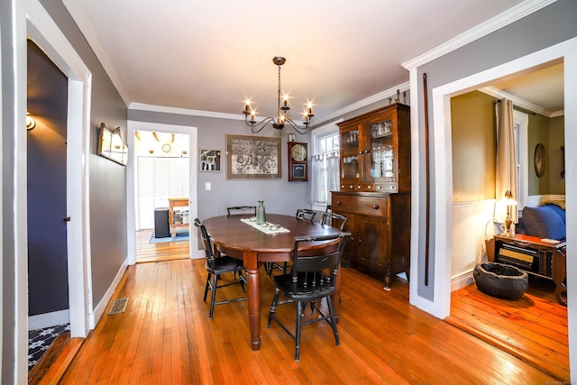 270 Berkshire Rd, Newtown, CT 06482 - dining area featuring a chandelier, visible vents, hardwood / wood-style flooring, and ornamental molding