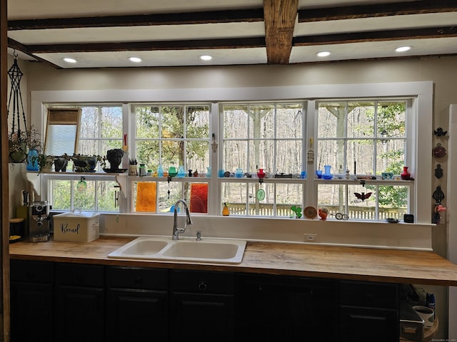 270 Berkshire Rd, Newtown, CT 06482 - kitchen with butcher block counters, beamed ceiling, a sink, and dark cabinets