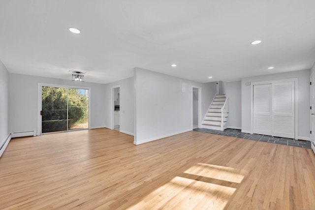 unfurnished living room featuring baseboards, recessed lighting, wood finished floors, and stairs
