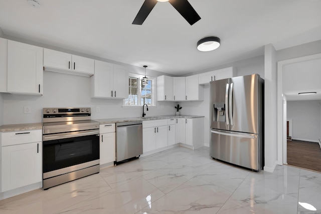 kitchen featuring white cabinetry, ceiling fan, stainless steel appliances, marble finish floor, and a sink