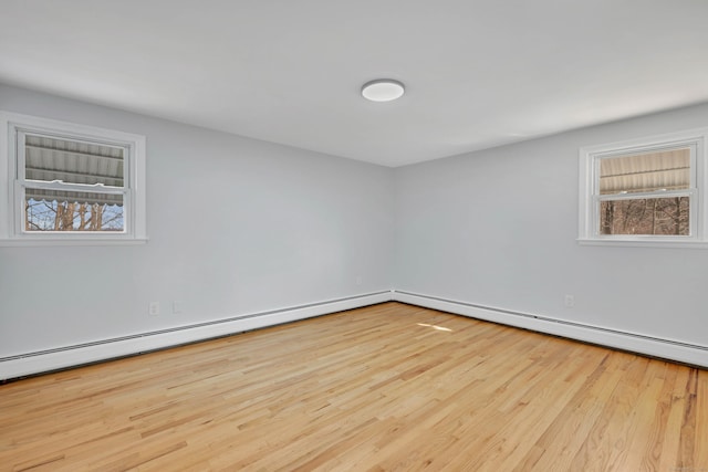unfurnished room featuring a baseboard radiator and wood finished floors