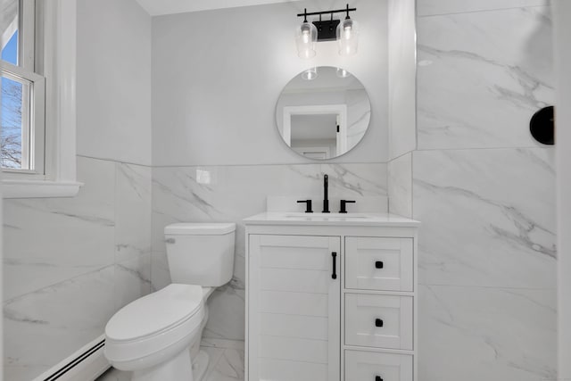 bathroom with vanity, a baseboard heating unit, tile walls, toilet, and marble finish floor