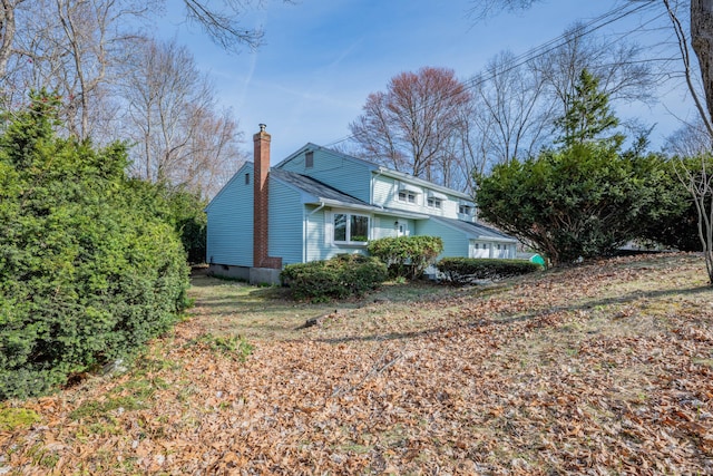 view of side of property with a chimney