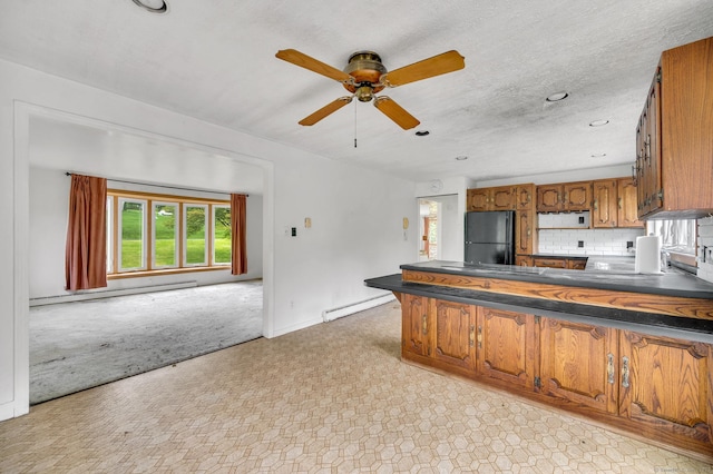 18 Hillcrest Dr, Somers, CT 06071 - kitchen featuring a baseboard heating unit, dark countertops, freestanding refrigerator, brown cabinets, and recessed lighting