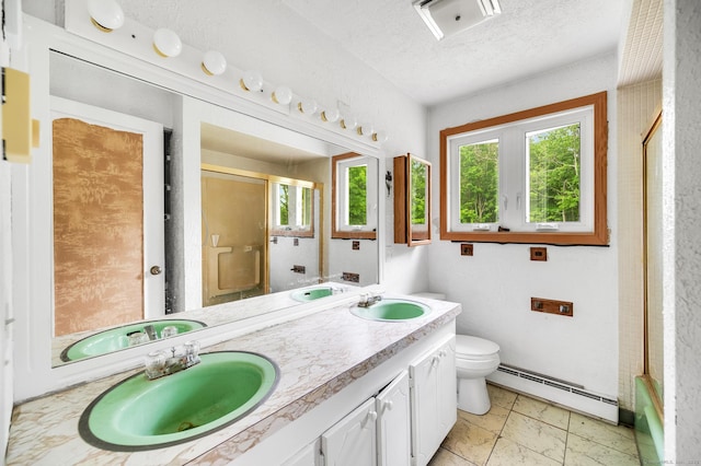 18 Hillcrest Dr, Somers, CT 06071 - bathroom featuring a baseboard radiator, a shower stall, toilet, double vanity, and a textured ceiling