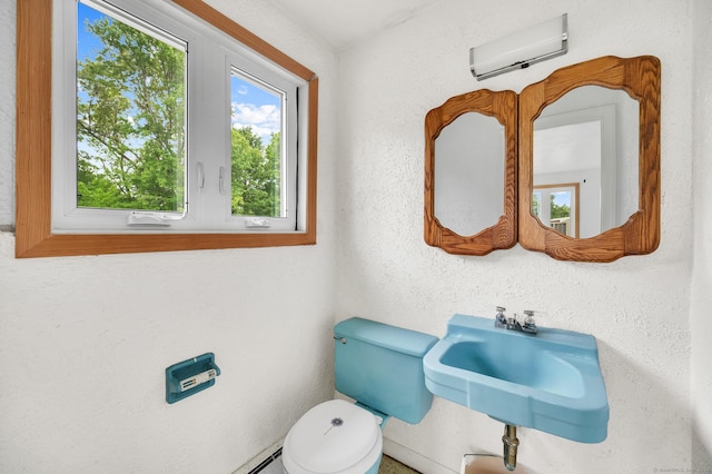 18 Hillcrest Dr, Somers, CT 06071 - half bathroom featuring an AC wall unit, toilet, and a sink