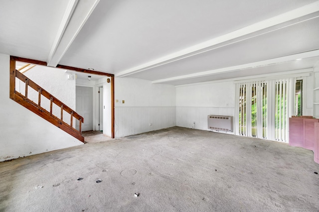 18 Hillcrest Dr, Somers, CT 06071 - unfurnished living room featuring heating unit, carpet, beam ceiling, a wainscoted wall, and stairs