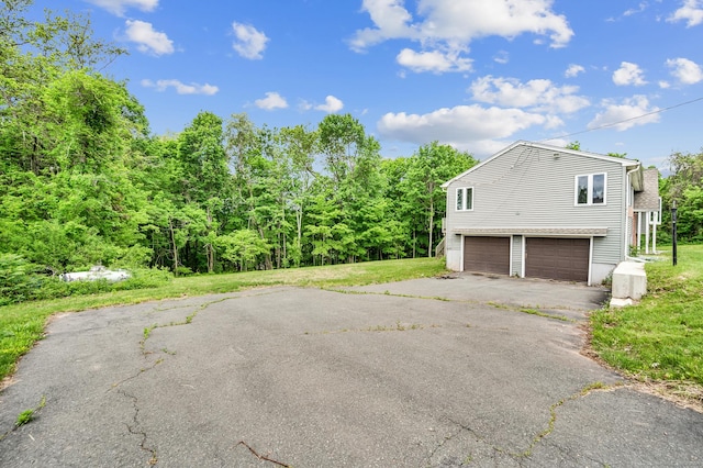 18 Hillcrest Dr, Somers, CT 06071 - view of property exterior with driveway, a garage, and a yard