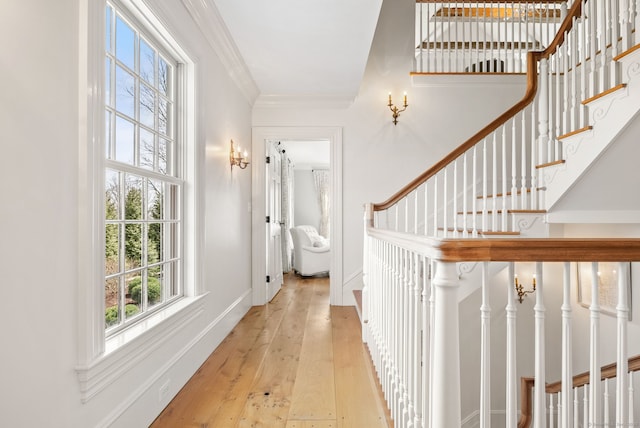 foyer entrance with hardwood / wood-style floors, ornamental molding, baseboards, and stairway