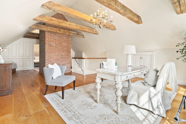 home office featuring lofted ceiling with beams, light wood-style flooring, and a chandelier