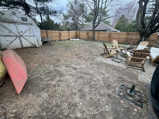 100 Ridgefield Ave, Waterbury, CT 06705 - fenced backyard featuring a shed and an outdoor fire pit