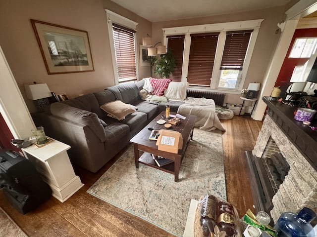 100 Ridgefield Ave, Waterbury, CT 06705 - living area with radiator heating unit, wood finished floors, and a fireplace
