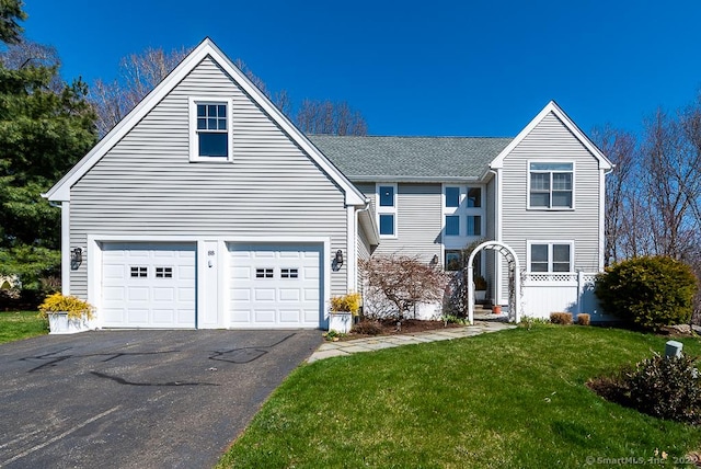 88 Sconset Ln, Guilford, CT 06437 - traditional home with an attached garage, a shingled roof, driveway, and a front yard