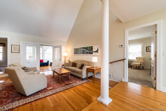 88 Sconset Ln, Guilford, CT 06437 - living room with wood finished floors, decorative columns, baseboards, and high vaulted ceiling