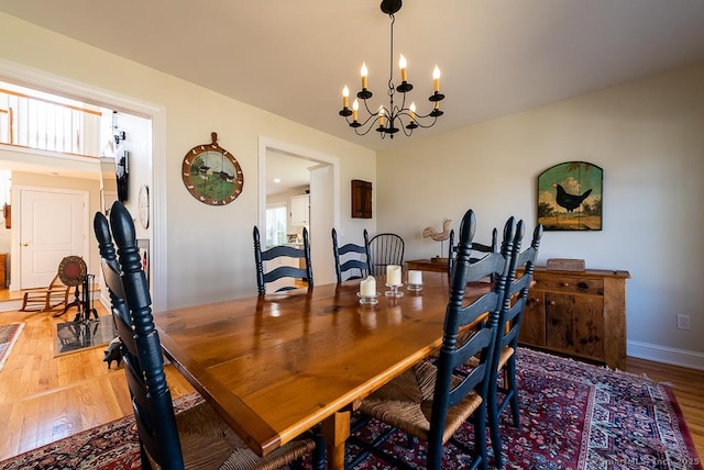 88 Sconset Ln, Guilford, CT 06437 - dining space featuring wood finished floors, an inviting chandelier, and baseboards
