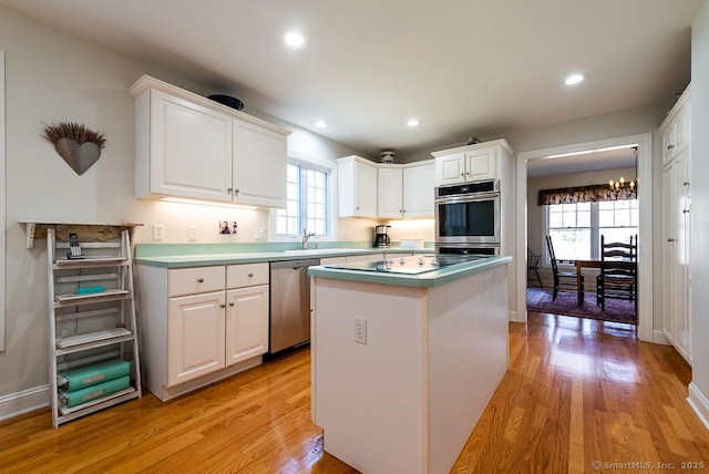 88 Sconset Ln, Guilford, CT 06437 - kitchen featuring stainless steel dishwasher, white cabinetry, and light wood-style floors