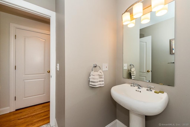 88 Sconset Ln, Guilford, CT 06437 - bathroom with baseboards, a sink, and wood finished floors