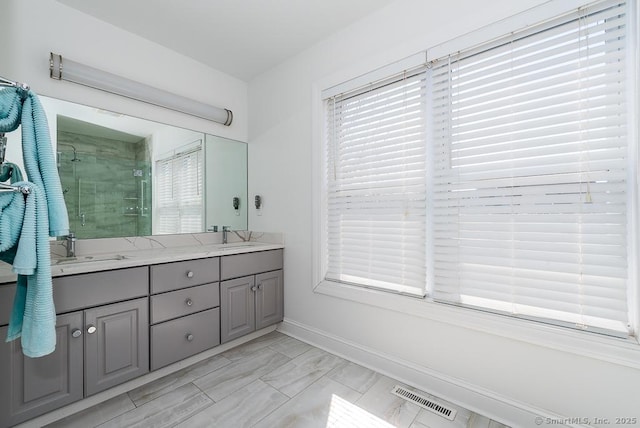 88 Sconset Ln, Guilford, CT 06437 - full bathroom with double vanity, a shower stall, visible vents, marble finish floor, and a sink