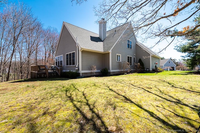 88 Sconset Ln, Guilford, CT 06437 - rear view of property with roof with shingles, a wooden deck, a lawn, and a chimney