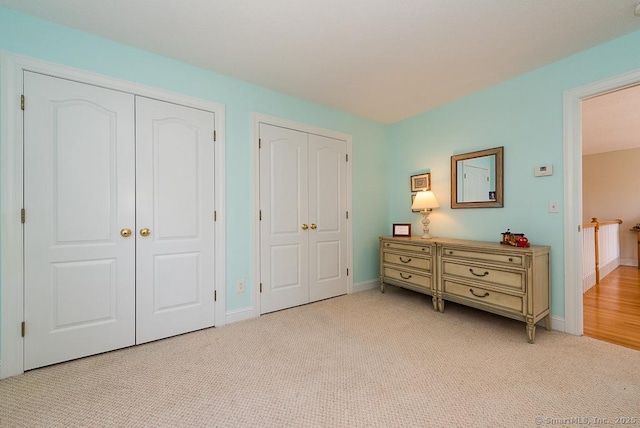 88 Sconset Ln, Guilford, CT 06437 - bedroom featuring baseboards, two closets, and light carpet