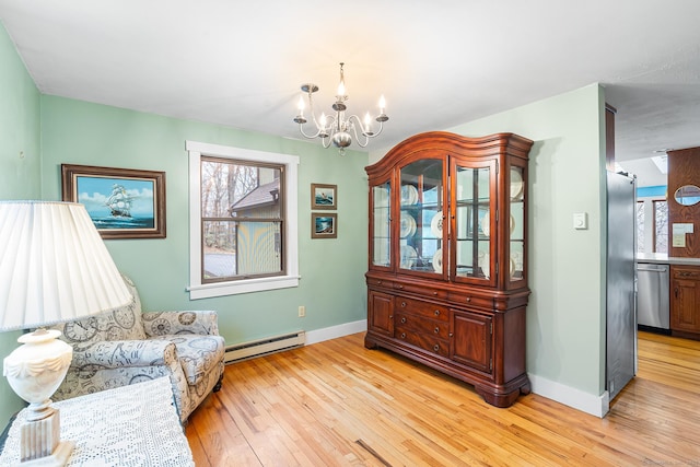 20 Sunrise Trl, East Lyme, CT 06333 - sitting room with a baseboard radiator, a chandelier, light wood finished floors, and baseboards