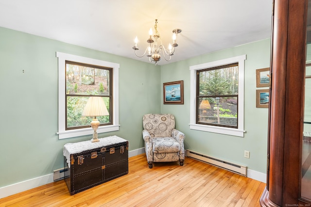 20 Sunrise Trl, East Lyme, CT 06333 - living area with a baseboard heating unit, a chandelier, plenty of natural light, and baseboards
