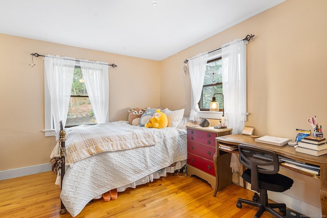 20 Sunrise Trl, East Lyme, CT 06333 - bedroom featuring multiple windows, wood finished floors, and baseboards