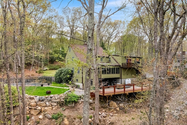 20 Sunrise Trl, East Lyme, CT 06333 - back of house featuring a deck, a pool, a lawn, and a view of trees