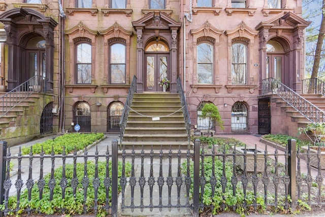 view of exterior entry with a gate and fence