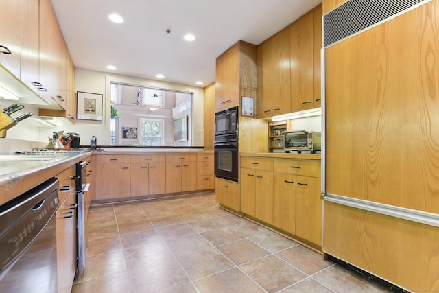 kitchen with light tile patterned flooring, a toaster, black appliances, and recessed lighting