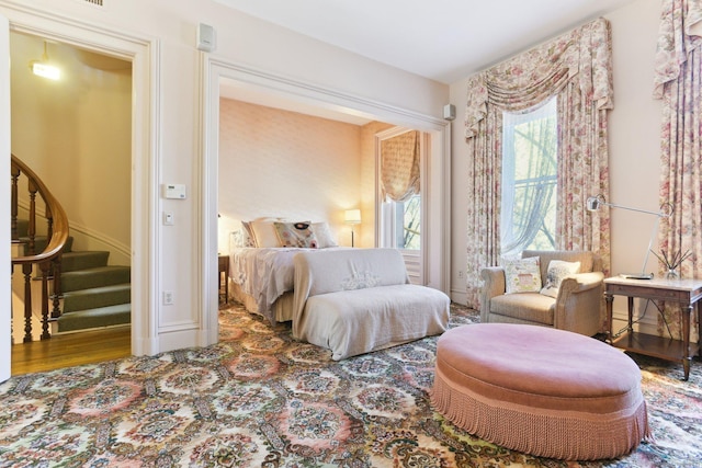 bedroom featuring baseboards and wood finished floors