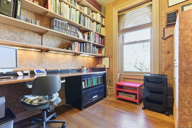 home office featuring wood-type flooring and built in study area