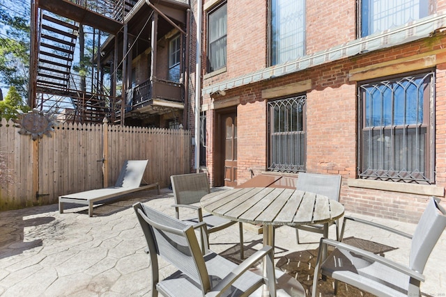 view of patio / terrace with outdoor dining space and fence
