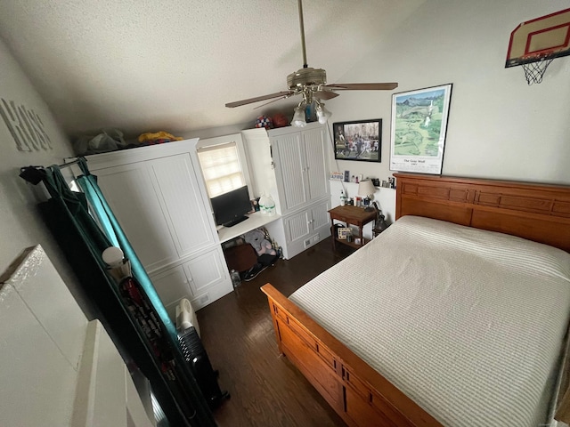 bedroom featuring a textured ceiling, ceiling fan, and dark wood-style floors