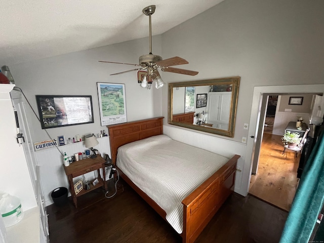 bedroom featuring lofted ceiling, wood finished floors, and a ceiling fan