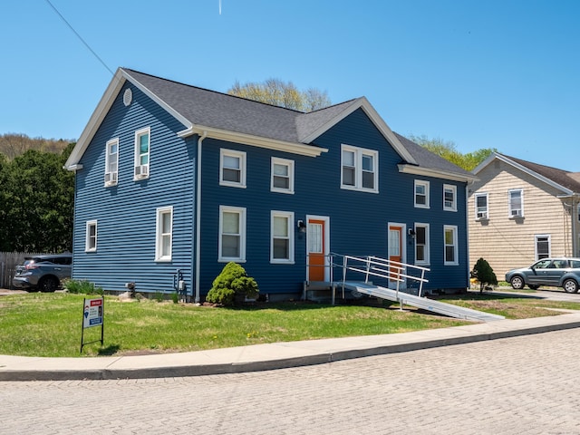 colonial home with a front lawn